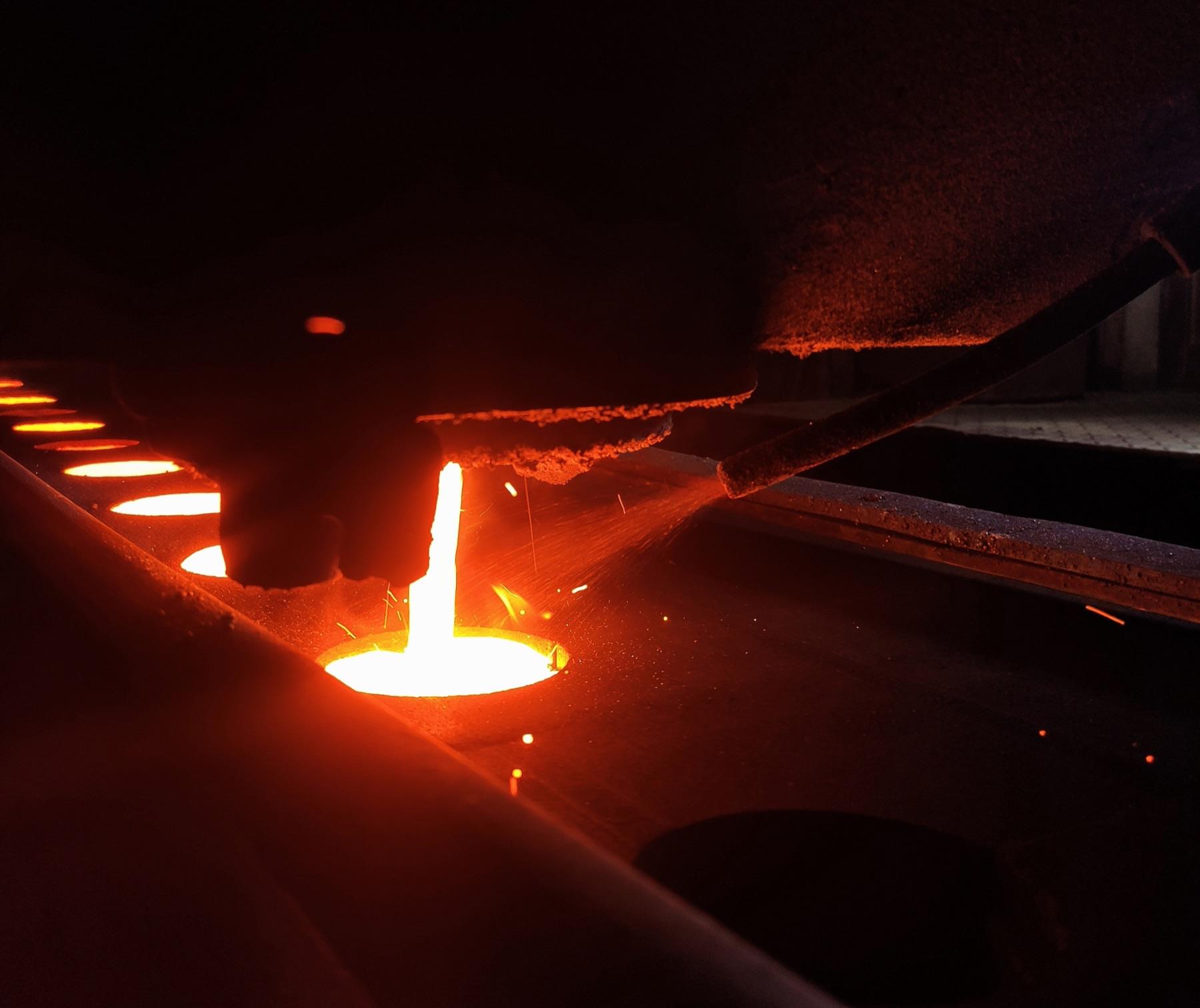 Molten cast iron being poured in a foundry